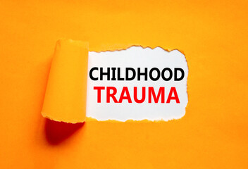 Childhood trauma symbol. Concept words Childhood trauma on beautiful white paper. Beautiful orange...