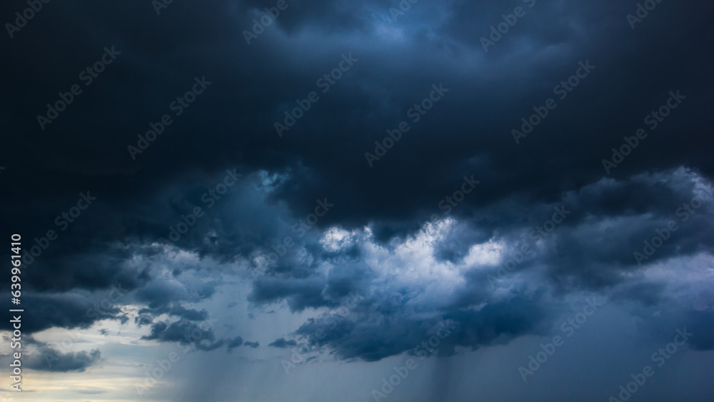 Poster the dark sky with heavy clouds converging and a violent storm before the rain.bad or moody weather s