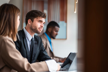 Male mature caucasian ceo businessman leader with diverse coworkers team executive managers group meeting. Multicultural professional businesspeople working together on research plan boardroom.