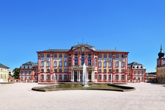 Bruchsal, Germany - August 2023: Baroque castle called Bruchsal Palace with fountain on sunny day