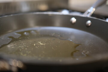 Pan with oil boiling close up