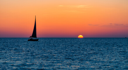 small sailboats floating on the sea in a beautiful sunset in high resolution and high sharpness