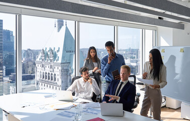 Busy diverse professional business people using laptop. International colleagues group and team leader having teamwork discussion managing plan working in corporate office meeting room. Copy space