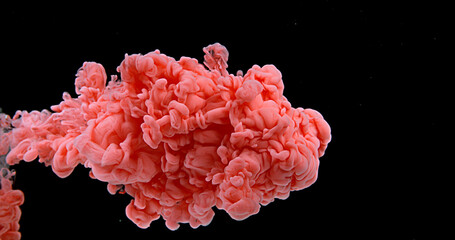 Red Ink entering Water against Black Background