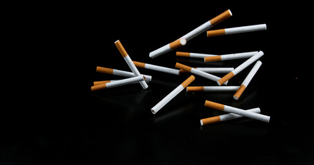 Cigarettes Falling against Black Background