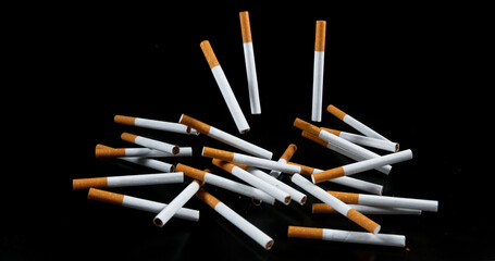 Cigarettes Falling against Black Background