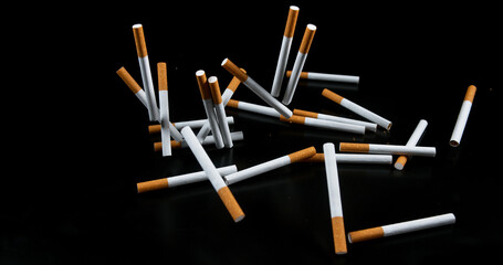 Cigarettes Falling against Black Background