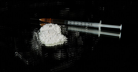 Hands of Woman and Drug against Black Background