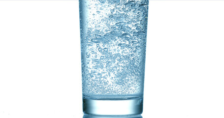 Water being poured into Glass against White Background