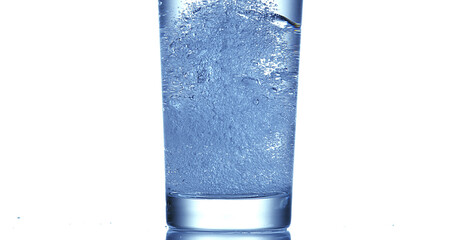 Water being poured into Glass against White Background