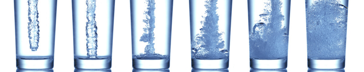 Water being poured into Glass against White Background