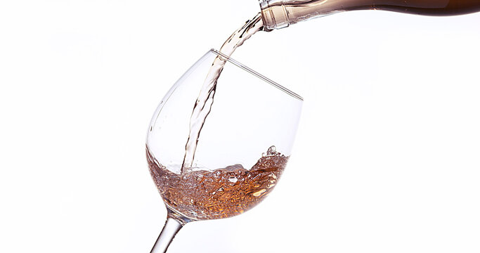 Pink Wine being poured into Glass, against White Background