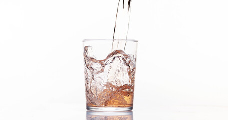 Pink Wine being poured into Glass, against White Background