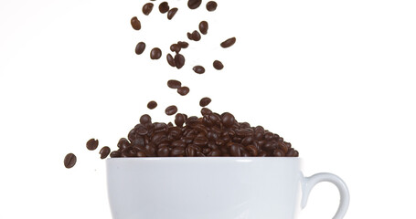Coffee Beans Falling into a Cup against White Background