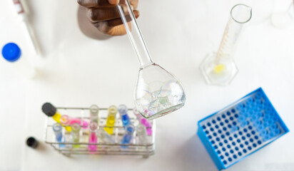 Close up female hands holding an erlenmeyer flask with bubble samples inside