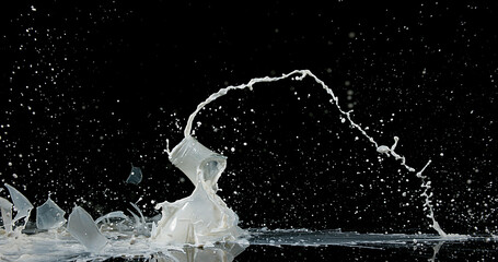 Bottle of Milk Falling and Exploging against Black Background - obrazy, fototapety, plakaty