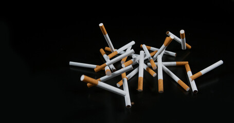 Cigarettes Falling against Black Background