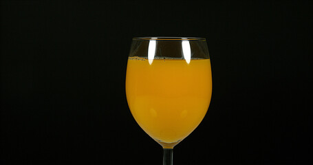 Glass of Orange against Black Background