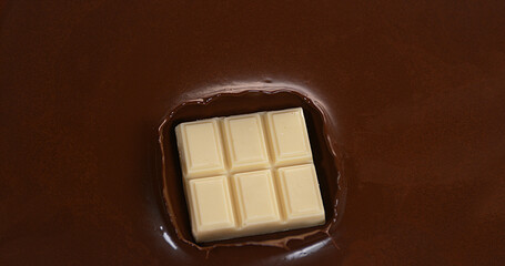 White Chocolate Tablet falling into Milk Chocolate