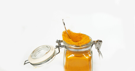 Turmeric, curcuma longa, Powder in a small Jar against White Background, Indian Spice