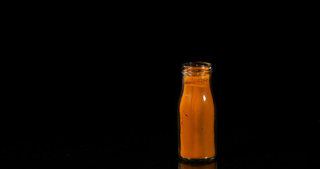 Turmeric, curcuma longa, Powder in a Small Jar against Black Background, Indian Spice
