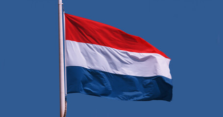 Luxembourgish Flag Waving in the Wind against blue sky