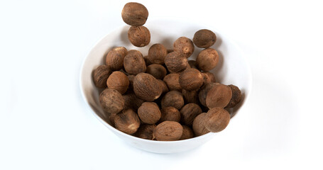 Nutmeg, myristica fragans, Nut falling against White Background