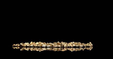 Gold Nugget Falling on Black Background