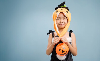 A little girl is wearing a witch costume for Halloween day.