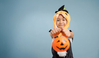 A little girl is wearing a witch costume for Halloween day.