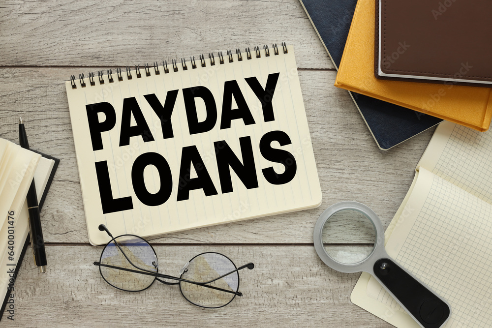 Poster payday loans concept. centered with text near magnifier and notepad