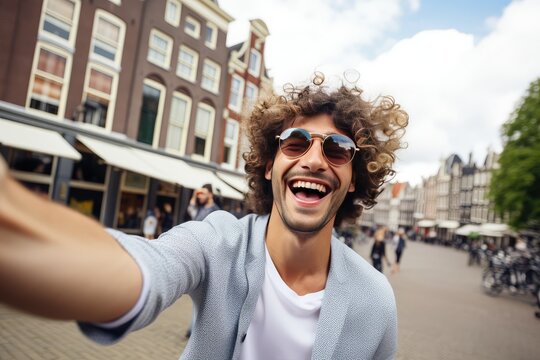 Happy tourist taking selfie picture in Amsterdam