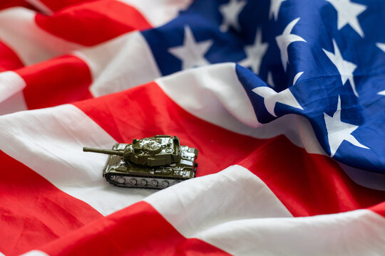 Toy tank with USA flag on white background