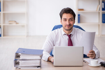 Young male employee working in the office