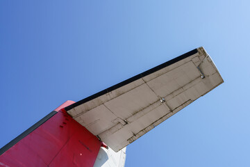 Detail of old propeller plane, wing with blue sky background