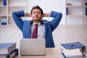 Young male employee working in the office