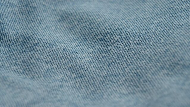 Blue worn denim casual jean. Macro shot. Rotation