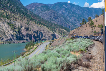 Rocky Mountaineer train and locomotive along Fraser River, British Columbia, Canada.