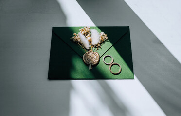 Wedding accessories, details: an envelope with a stamp, gold rings, boutonniere made of reeds and...