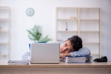 Young male employee working in the office