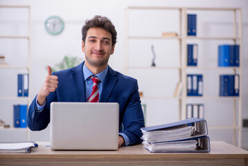 Naklejka premium Young male employee working in the office