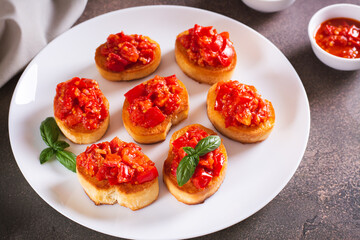 Sandwiches on toast with fried tomatoes and garlic on a plate