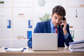 Obraz premium Young male employee working in the office