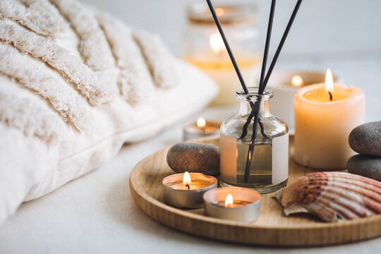 Cozy corner for home meditation and relaxation. Aroma diffuser, burning candles, stones for comfort, pleasure, aromatherapy. Decor for apartment, house, indoors design