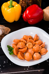 Boiled carrot dumplings with meat with sweet pepper, herbs and spices.