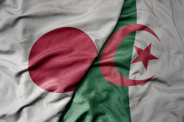 big waving national colorful flag of japan and national flag of algeria .