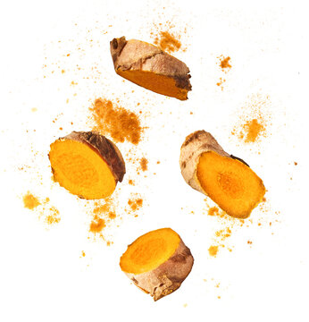 Fresh turmeric root falling in the air isolated