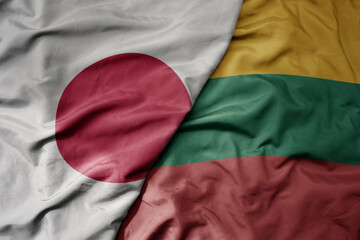 big waving national colorful flag of japan and national flag of lithuania .