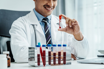 Clinical Laboratory Tests, Asian hematologist checking medically necessary blood tests. ordered by...