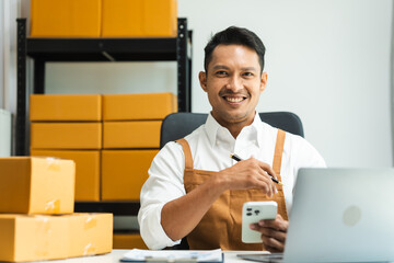 Startup SME small business entrepreneur of freelance Asian Indian man wearing apron prepare parcel...